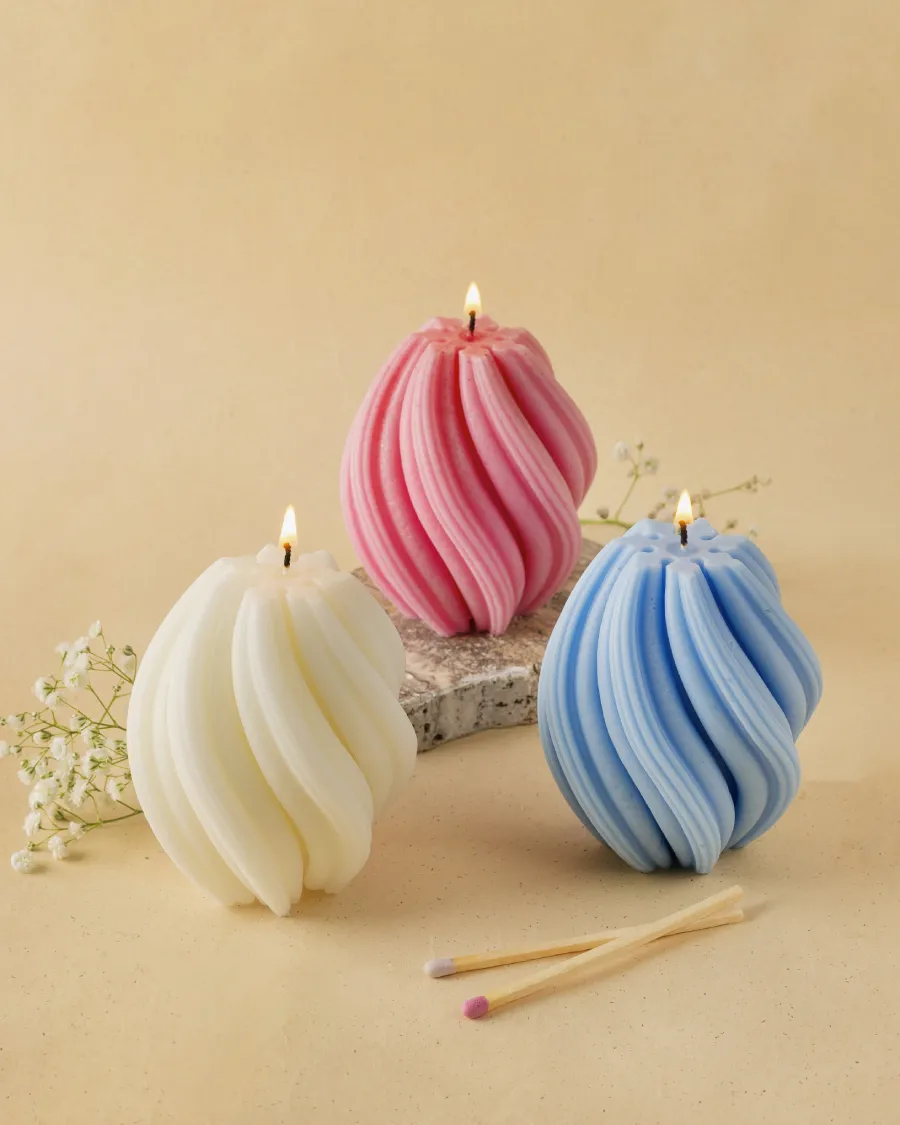 Twirl Candles in white, pink, and blue by Windowsill, lit and displayed with matches, showcasing aesthetic decor.